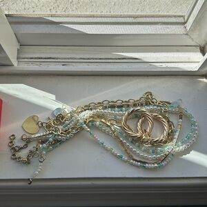 Assortment of beaded necklaces and gold earrings